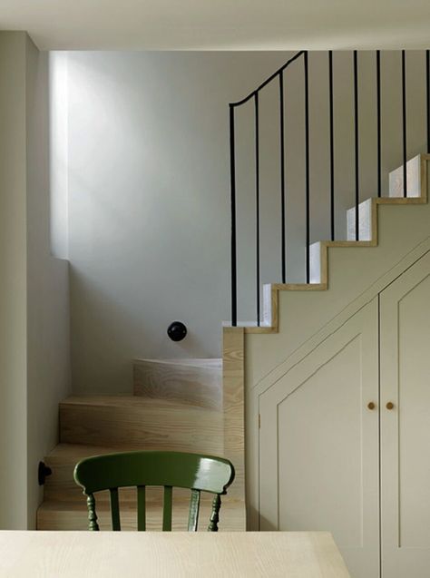 Architects Michaelis Boyd had the stairs moved in this Notting Hill townhouse to create more livable space. Sloped cabinets were built in, providing more storage space in the kitchen area. See A Notting Hill Townhouse Tailored for Living by Charles Mellersh. Photograph by Chris Tubbs. Cottage Stairs, Under Stairs Nook, Narrow Staircase, London Family, Staircase Storage, Cottage Renovation, Built In Furniture, Understairs Storage, Stair Storage