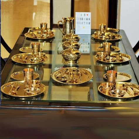 Buy a traditional Brass royal dinner set from Indian Bartan. The 6 Person Royal Brass Dinner Set is made in India with brass. It includes 6 Full Plates,6 Half Plates,6 Glasses,6 Bowls,6 Dish Plates,3 Serving Bowls with lid,1 Rice Plate,1 Jug,12 Spoons,3 Serving Spoons. Indian Kitchen Utensils, Royal Dinner, Vintage Kitchen Gadgets, Dinnerware Set Modern, Serving Bowls With Lids, Crockery Design, Modern Kitchen Storage, Formal Table Setting, Kitchenware Products