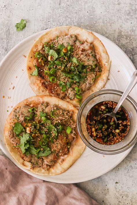 Prepare yourself for an exciting twist on traditional tacos—introducing Smash Dumpling Tacos! Inspired by the viral trend, these quick and easy tacos feature a flavorful pork dumpling filling, smashed onto a tortilla, and cooked until perfectly crispy. Garnish with sesame seeds, green onions, and cilantro, then drizzle with a mouthwatering dipping sauce for a deliciously unique dinner. Smashed Dumpling Tacos, Smash Dumpling Tacos, Taco Dumplings, Smash Dumplings, Pork Dumpling Filling, Dumpling Tacos, Smashed Tacos, Traditional Tacos, Easy Tacos