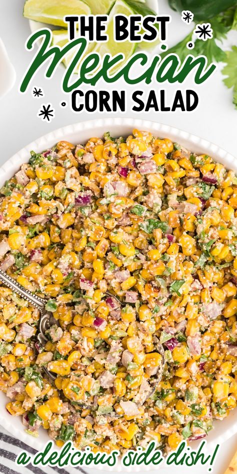 Close-up overhead shot of Mexican corn salad garnished with parsley then topped with Cotija cheese and lime slices. Jalapeno Corn Salad Recipe, Mexican Corn Skillet, Corn Cotija Salad, Hot Corn Side Dish, Mexican Street Corn Jalapeno Poppers, Elote Side Dish, Corn And Jalapeno Side Dish, Trader Joes Side Dish Recipes, Sides To Go With Tri Tip