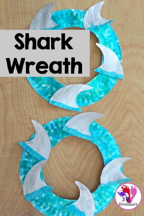 Shark Fin Wreath Craft for Shark Week - that kids can make with a shark cookie cutter and a paper plate. A super easy wreath for all ages.- 3Dinosaurs.com Toddler Shark Craft, Shark Week Art Projects For Kids, Shark Week For Toddlers, Shark Craft For Preschool, Easy Shark Craft, Shark Art Project, Shark Week Crafts For Toddlers, Shark Art For Toddlers, Easy Shark Crafts For Kids