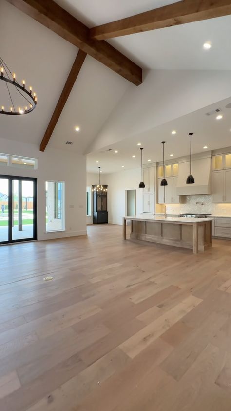 Carrasco Homes | Save for inspo ✨ this stunning open-floor #kitchen, complete with neutral earth-tones, custom lighting, and high-end sterling appliance.... | Instagram 1 Story High Ceiling House, Homes With Light Wood Floors, Cathedral Ceiling Kitchen Living Room, Large Open Concept Kitchen Living Room, Kitchen To Living Room Floor Transition, Building A House Aesthetic, 2 Story Great Room Ideas, Earth Tone House, Kitchen With Cathedral Ceiling