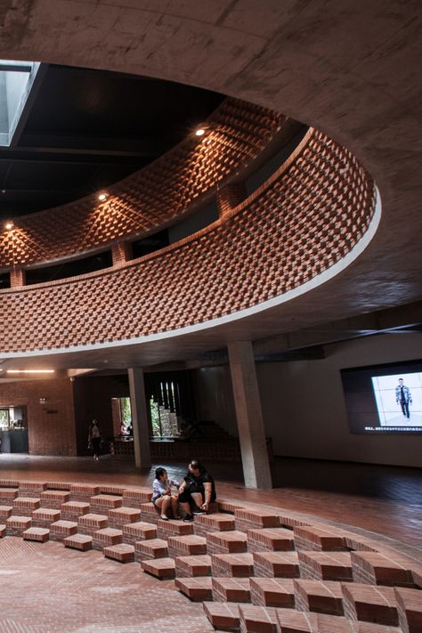 The Red Brick Art Museum in Bejing, China, designed by architect Dong Yugan, uses brick for interior and exterior cladding incorporating sculptural surfaces and structures. Brick Construction Architecture, Museum Facade Design, Cheap Architecture, Brick Interior Design, Brick Sculpture, Structuralism, Architectural Finishes, Circular Buildings, Brick Works