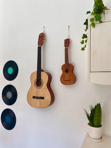 Ukulele Room Decor, Ukulele On Wall Decor, Guitar And Ukulele On Wall, Guitar In Room Aesthetic, Ukulele On Wall, Ukulele Aesthetic Vintage, Guitar On Wall Decor, Musician Room Aesthetic, Guitar Room Aesthetic