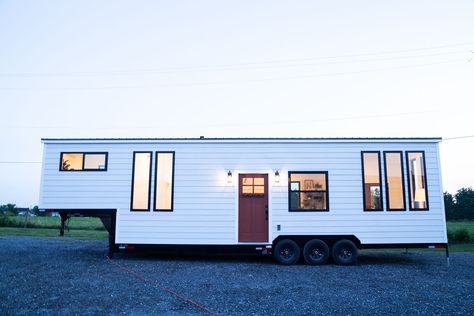 Tiny homes keep getting better and more impressive every day with new projects being developed all over the world. One of the latest ones is this amazing Gooseneck trailer home designed and built by studio Liberation Tiny Homes. Its overall dimensions are 40′ x 10′ x 13’6” and inside there’s a total of 400 square... The post A Farmhouse-Style Tiny Home With The Most Charming And Welcoming Interior appeared first on Home Decorating Trends - Homedit. Farmhouse Tiny House, Gooseneck Tiny House, Tongue And Groove Walls, Black Accent Walls, Tiny House Talk, Glass Garage Door, Small Tiny House, Tiny House Plan, Big Bathroom