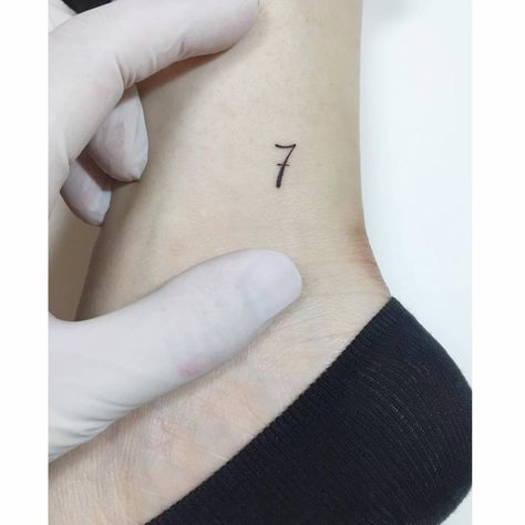 Minimalistic number "7" tattoo located on the ankle. Tattoo 7 Number Design, Tiny 7 Tattoo, Ankle Number Tattoo, Number Tattoo Ankle, 7 Number Tattoo, Number 7 Tattoo Design, Number Seven Tattoo, 7 Tattoo Number Design, Number 7 Tattoo