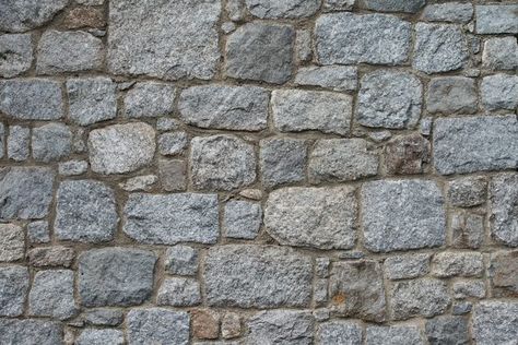 If you're looking to add definition and texture to a plain wall, consider adding a splash of stone without the cost of hiring a mason. Using a plaster stone stencil, some hand tools and joint compound (also known as drywall mud), you can create a faux brick or rough stone wall all by yourself. Faux Stone Wall Interior, Faux Rock Walls, Fake Stone Wall, Stone Wall Texture, Faux Stone Walls, Brick Face, Stone Walls Interior, Brick Interior Wall, Wall Paneling Diy