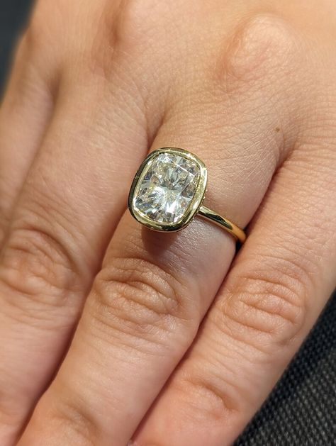 MAIN STONE
Type: Braverman Moissanite
Cut: Cushion
Color: D
Clarity: VVS

#Bezel #Set #3ct #Cushion #cut #Moissanite #Solitaire #Promise #Ring #14K #Yellow #Gold #Hidden #Diamond #Halo #Statement #Ring #Custom #Engagement #Ring #bezel #set #ring #hidden #halo #ring #moissanite #solitaire #moissanite #ring #cushion #moissanite #diamond #hidden #halo #engagement #ring #promise #ring #statement #ring #3ct #moissanite #ring #custom #ring #for #her #wedding #ring #anniversary #ring Elongated Cushion Bezel Engagement Ring, Ring Images, Engagement Ring Types, Anniversary Rings For Her, Wedding Anniversary Ring, Ring Inspo, Future Engagement Rings, Cushion Cut Moissanite, Moissanite Engagement Ring Solitaire