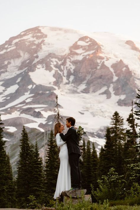 A couple in wedding attire stands on a log in front of Mount Rainier during their Mount Rainier elopement Mt Rainier National Park Wedding, Washington Elopement Photography, Mount Rainier National Park Elopement, Mount Rainier Engagement Photos, Mt Rainier Wedding, Mt Rainier Engagement Photos, Mount Rainier Wedding, Mount Rainier Elopement, Mt Rainier Elopement