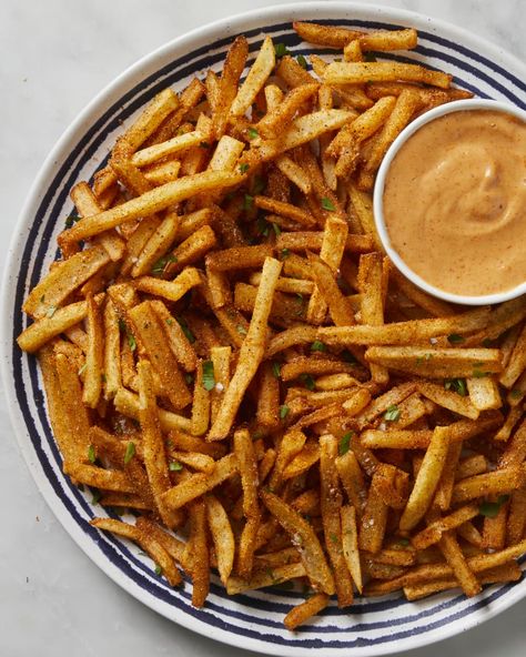 Overhead shot of fries on a blue and white striped plate with a side of remoulade in a small bowl on the plate. Cajun Fries Recipe, Cajun Seasoning Recipe, French Fries At Home, Fries At Home, Cajun Fries, Homemade Cajun Seasoning, Making Fried Chicken, Crispy French Fries, Fries Recipe