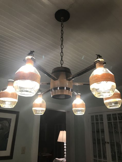 Chandelier made from Blantons bourbon bottles. Bourbon Bottle Decor, Empty Whiskey Bottle Ideas, Blantons Bottle Ideas, Bourbon Bottle Crafts, Blantons Bourbon, Bourbon Barrel Furniture, Cave Lighting, Whiskey Bottle Crafts, Bottle Lighting