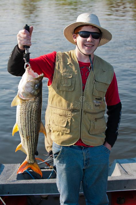 Teenage Fisherman - Tiger Fish. A young lad with his first catch of the mighty T #Sponsored , #SPONSORED, #sponsored, #Fisherman, #Fish, #catch, #Tiger Fisherman Outfit, Tiger Fish, Man Posing, Fish Pose, Fishing Party, Fishing Vessel, Fishing Pictures, Fish Stock, Boy Fishing