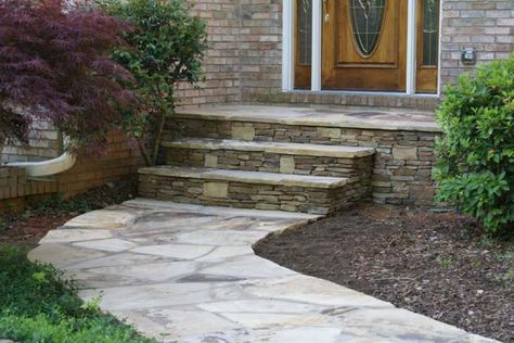 Flagstone walkway leading up to front door steps. The step risers are also made of natural stone with some larger light coloured blocks mixed in for character. Picture compliments of www.nichegardenslandscaping.com Stone Porch Ideas, Stone Walkways To Front Door, Stairs To Front Door, Walkways To Front Door, Stone Porch, Front Door Landscaping, Stamped Concrete Walkway, Flagstone Steps, Stone Walkways