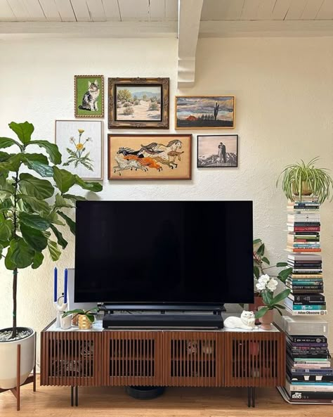 TV Stand Decor Ideas: 8 Ways To Elevate Your Living Room | Castlery US Gallery Wall With Tv Tv Stands, Tv Stand In Bedroom Ideas, Wall Decor Above Tv Stand, Tv Wall Decor Mid Century Modern, Plant Next To Tv, Tv Stand Bedroom Ideas, Above Tv Decor Living Rooms, Pictures Above Tv, Gallery Wall Above Tv