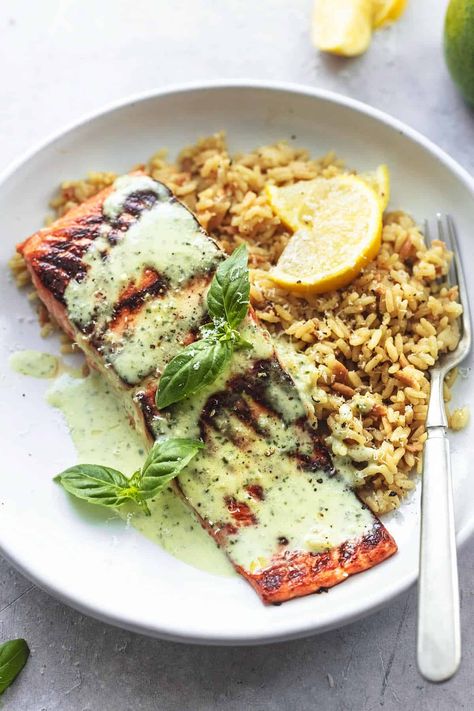 This easy recipe for baked salmon with pesto cream sauce takes tender, tasty, flaky salmon, bakes it at the optimal time and temperature, and then smothers it in a delicious, herby, garlicky pesto cream sauce. You'll never want to put your fork down! Salmon With Pesto, Salmon With Cream Sauce, Pesto Cream Sauce, Pesto Salmon, Oven Baked Salmon, Lime Salmon, Creamy Pesto, Baked Salmon Recipes, Salmon Dishes