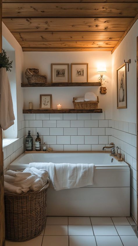 Cozy alpine chalet bathroom with white tiles, a centered bathtub, wooden shelves, and warm lighting for a welcoming Cosy Small Bathroom Ideas, Bathroom Cozy Aesthetic, Zen Small Bathroom, Apartment Bathroom Aesthetic, Cozy Small Bathroom, Small Bathroom Solutions, Windowless Bathroom, Cosy Bathroom, City Bathrooms