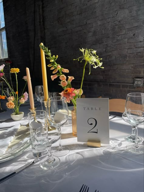 An industrial wedding with colored candles and wildflower bud vases for a summer wedding in Brooklyn. Vibrant Minimalist Wedding, Wildflower Minimalist Wedding, Fall Flower Bud Vase, Bud Vase Table Decor Wedding, Wedding Flower Arrangements Summer Table Centerpieces, Colored Tapered Candles Wedding, Wedding Centerpiece Colorful, Bud Vases And Votives Wedding Centerpiece, Simple Colorful Centerpieces