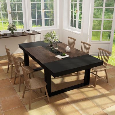 Create a space that stands out from its surroundings with the 87" Dining Table. With its clean lines and outstanding appearance, the Dining Table is designed to stand out from many worthy endeavors. Constructed of durable fiberboard in black and brown, sturdy metal Legs is a versatile decorative update for the modern home. Whether it's in a dining room as a table for up to 8 people or in a home office as a conference table. Color: Black/Brown | Wildon Home® Bevin 86.8" Dining Table Wood / Metal