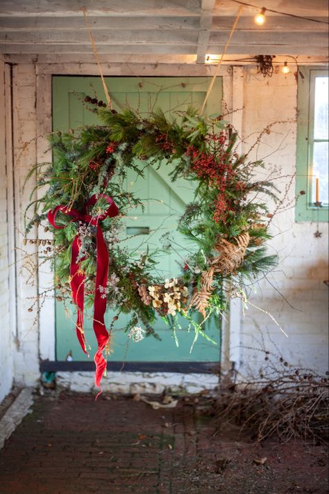 A giant  Christmas wreath made with fresh foliage and dried flowers.  Displayed in my flower studio in Kent, UK Alternative Christmas Wreath, Giant Wreath Christmas, Large Wreath Outdoor, Foraged Christmas Wreath, Foraged Wreath, Giant Christmas Wreath, Giant Wreath, Extra Large Wreath, Giants Wreath