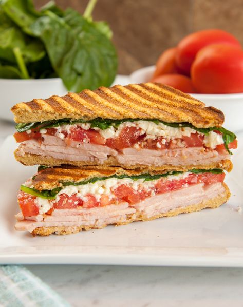 This grilled sandwich combines the delicious flavors of feta cheese, tomatoes, spinach, turkey, and garlic aioli, in a tasty Mediterranean-style. Layer it all between slices of Martin’s Whole Wheat Potato Bread and grill it in a panini press for a warm, crisp crust. Sandwiches are easy to make and easy to pack, making them great school lunches! Turkey Panini Sandwiches, Turkey Panini Recipes, Mediterranean Sandwich, Turkey Panini, Potato Rolls, Healthy Sandwich Recipes, Panini Sandwich, Panini Recipes, Panini Sandwiches