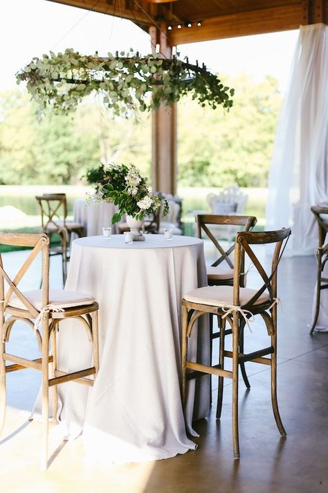 Crossback bar stools, white linens, and greenery for a beautiful cocktail hour. Rentals by Southern Events Party Rental Company | Franklin, Nashville, Middle Tennessee Event Lounge Furniture, Reception Seating Layout, Wedding Cocktail Table, Seating Layout, Wedding Cocktail Tables, Cocktail Table Decor, Table Decoration Ideas, Cocktail Wedding Reception, Wedding Reception Seating