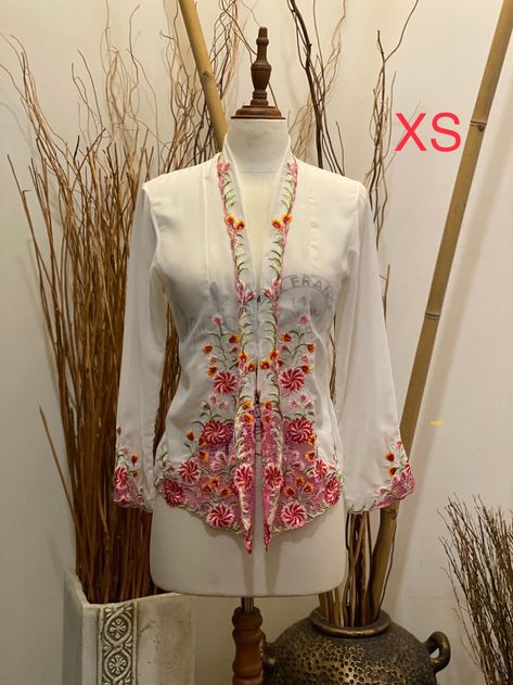 Embrace the exquisite craftsmanship and rich cultural heritage with our Handcrafted Nyonya Kebaya. This traditional blouse-dress ensemble, a cherished artifact of the Peranakan legacy, blends the intricate artistry of Chinese and Malay/Indonesian influences into a piece of wearable art. Made from the finest Japanese voile , our Kebaya offers a delicate, semi-transparent allure, ensuring both elegance and comfort. The vibrant, hand-embroidered designs feature an array of floral and geometric moti Kebaya Malaysia, Kebaya Nyonya, Nyonya Kebaya, Embroidered Designs, Traditional Attire, Party Stuff, Semi Transparent, Cotton Voile, Cultural Heritage