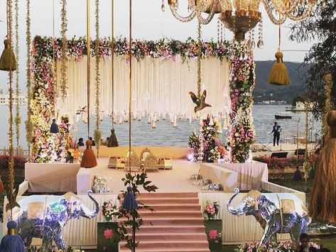 Elegant yet classy beautiful lake side mandap decor in Udaipur(RAj.). Looking for destination wedding have a look on one stop destination wedding planner in the city of lakes.#wedwingzevent #eventplanner #eventorganiser #eventdesign #eventmanagement Lake Side Wedding, Lake Side, Mandap Decor, Desi Wedding Decor, Wedding Planning Decor, Wedding Backdrop Design, Wedding Mandap, Wedding Design Decoration, Lakeside Wedding