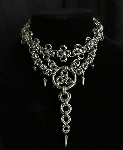 Transform your look with this striking handmade stainless steel chainmail necklace, featuring an elegant layered design, and a dramatic long centerpiece. Meticulously crafted, this necklace combines intricate chainmail techniques with a contemporary touch.  Features :  * Material : Premium stainless steel, offering durability, strength, and resistance to tarnish * Design :          - Layered Structure : Multiple layers of chainmail create a visually captivating, textured effect with rich depth Metal Chainmail Choker As A Gift, Silver Chainmail Necklaces, Silver Metal Chainmail Choker, Luxury Metal Chainmail Necklace, Chainmail Choker, Gothic Metal Chainmail Choker, Chainmaille Jewelry Patterns, Punk Necklace, Chainmail Necklace