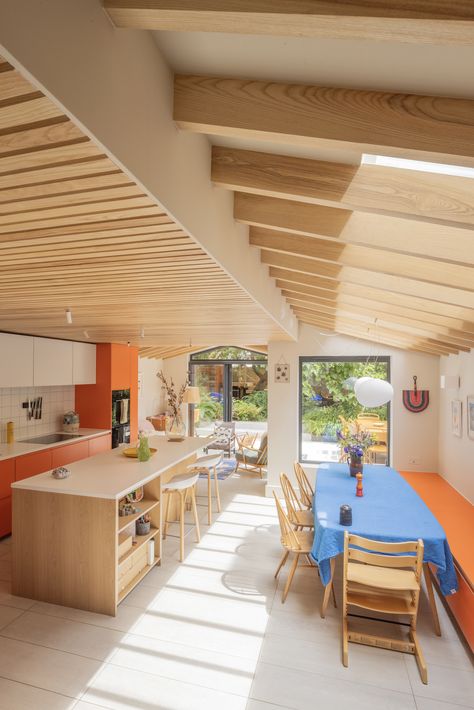 The bold Formica Clementine plywood kitchen fronts are balanced by the Arpa Bianco Nube faced wall units and the warm, natural oak veneered plywood of the island, in this light-filled rear kitchen extension, customising IKEA Metod or Sektion kitchen units.  Architect: A Small Studio Photographer: Manuel Vazquez Kitchen: Plykea Kitchens  #plywoodkitchen #birchplywood #plywood #ikeahack #kitchenideas #kitchentrends Kitchen Island Plywood, Rear Kitchen Extension, Oak Shelving Unit, Sektion Kitchen, Formica Laminate, Plywood Kitchen, Ikea Kitchen Cabinets, Orange Kitchen, Concrete Kitchen