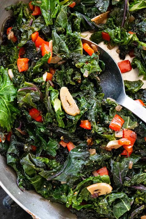 Sauteed kale is easy to make and a nutritious side dish. Just chop and cook in a hot skillet with aromatic shallots, bell peppers, and garlic. #kale #sidedish #healthyrecipes #sauteedkale Kale Dinner Recipes, Kale Dinner, Kale Side Dish, Kale Benefits Health, Garlic Kale, How To Cook Kale, Sauteed Kale, Kale Recipes, Sauteed Vegetables