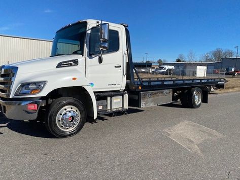 This truck is basically still brand new and very well equipped with a chevron steel removable rail, 21 foot bed 102 inch wide, traction tread rear tires, alloy wheels, air ride rear dump suspension for easy loading, Miller industries build with wheel lift, all chains necessary to tow included, stainless drawer toolbox, Whelen strobe light bar, aluminum diesel fuel tank, air ride seat, cd player, power mirrors, automatic transmission, power windows and pro appearance package. $85,995. Trucks For Sell, Flatbed Towing, Tire Pictures, Flatbed Trailer, Car Carrier, Video Call With Boyfriend Screen Photo, Driving Pictures, Doctor Picture, Bodyweight Workout Beginner