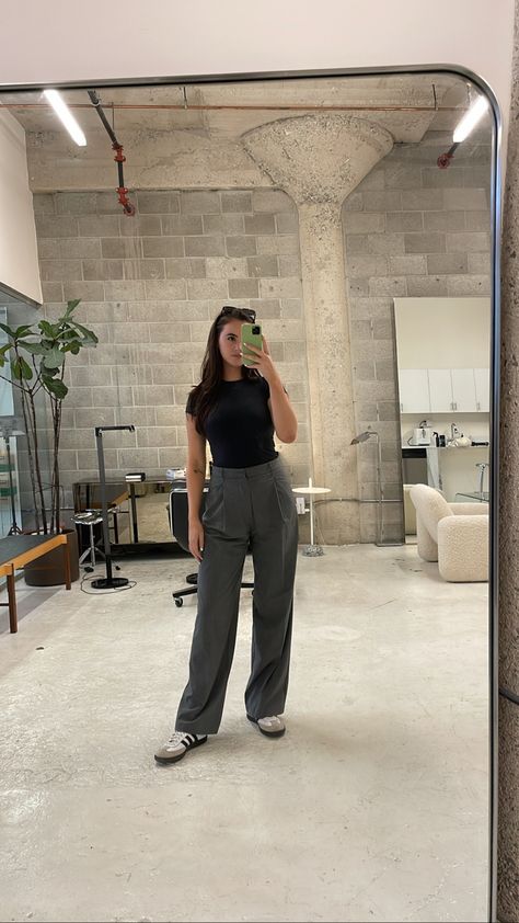 Brunette woman taking a mirror selfie of her outfit in a minder studio space. She’s wearing a black skims fitted t shirt, grey trousers, and adidas samba sneakers. Sambas Adidas Outfit, Trendy Sneakers For Women, Adidas Samba Outfit Women, Sambas Adidas Women Outfit, Adidas Samba Women, Samba Adidas Outfit, Adidas Gazelle Outfit, Samba Outfit Ideas, Adidas Samba Outfits