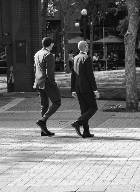 Black and white photography of two men walking threw the city in sync with each other Two Men Walking Together, Model For Drawing, Black Blinds, Looking Over Shoulder, Deep Romantic, 60s Men, Walking People, Boss Woman, Male References