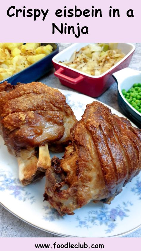 Two crispy eisbein on a serving platter next to side dishes of vegetables. Eisbein Recipe, German Fried Potatoes, Chicken And Ham Pie, Beef Schnitzel, Ham Hock Soup, Sauteed Potatoes, Pork Hock, Multi Cooker, Ninja Recipes