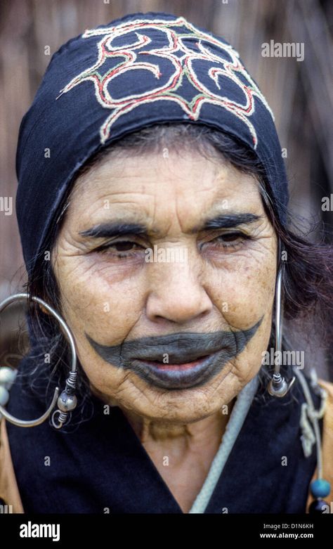 Download this stock image: An elderly Ainu woman shows off a childhood tattoo on her face outside her village home in 1962 on the island of Hokkaido, Japan. - D1N6KH from Alamy's library of millions of high resolution stock photos, illustrations and vectors. Tattoo On Face, Ainu People, Japanese Traditional Clothing, Village Home, Tattoo For Son, Lip Tattoos, Face Tattoos, Face Tattoo, Symbolic Tattoos