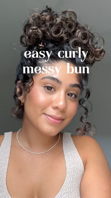 Curly Buns With Bangs, Curly Hair High Bun Tutorial, Long Curly Hair Bun Tutorial, How To Do A Curly Bun, Messy Bun Curly Hair Natural Curls, Messy Buns For Curly Hair, Curly Top Bun, Messy Bun Tutorial Curly Hair, Curly Hair Messy Bun Tutorial