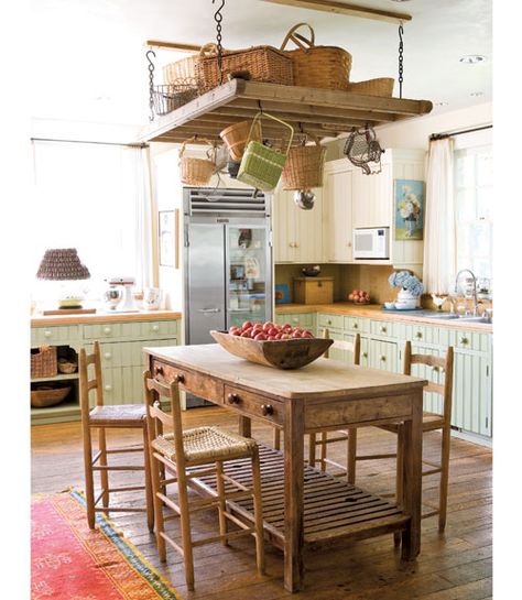 In this kitchen, sage and cream cabinetry is paired with butcher-block countertops and a marble backsplash.   - CountryLiving.com Kitchen Cabinet Color Ideas, Island Table, Kitchen Pot, Butcher Block Countertops, Cozy Kitchen, Kitchen Cabinet Colors, Interior Modern, Pot Rack, Shabby Chic Kitchen