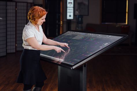 Ideum Drafting Table 65 | The Drafting Table 65 is the first to incorporate 3M™ projected-capacitive touch technology. It is a fully integrated system that incorporates a large multitouch screen, oriented to a 30-degree angle. The Drafting Table 65 P-CAP is impervious to light interference and supports up to 60 touch points for multi-user interaction. Multitouch Table, Luxury Bunkers, Touch Screen Table, Interactive Table, Drawing Desk, Sci Fi Props, Computer Desk Setup, Drafting Table, Touch Table