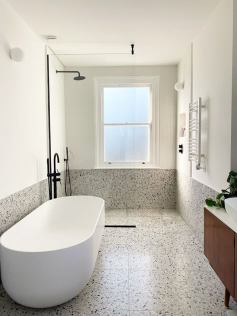 Real terrazzo bathroom with walk in shower and white freestanding bath Microcement Terrazzo Bathroom, Large Tiles Bathroom, Terrazo Bathroom Flooring, Terazzo Floor Bathroom, Beige Terrazzo Bathroom, Terrazo Bathroom Floor, Terrazzo Architecture, Terrazzo Bathroom Wall, Bathroom Terrazzo Floor