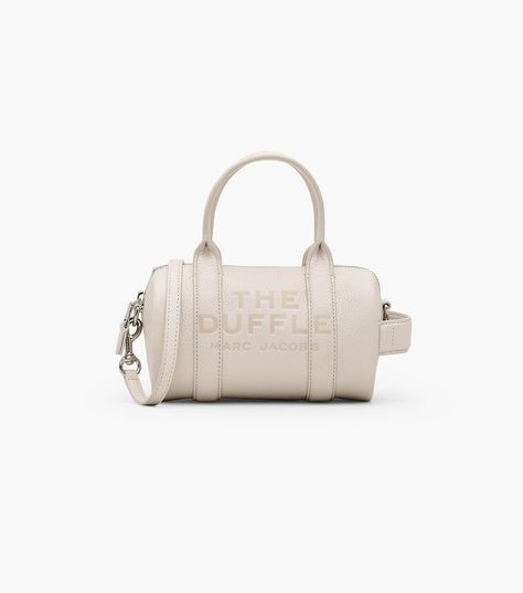 The mini version of our bestselling Duffle Bag is crafted in supple full-grain leather and finished with our signature embossed branding. Shop Marc Jacobs The Leather Mini Duffle Bag Mini Duffle Bag, Buckle Bags, Mini Bucket Bags, Sack Bag, Leather Belt Bag, Crossbody Tote Bag, Metallic Sandals, Leather Bucket Bag, Wallet Accessories