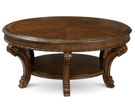 The generous 44" round top of the Old World Round Cocktail Table showcases the beautiful sunburst of book matched cherry cathedral veneers bordered with herringbone inlay and avodire cross banding. Six legs placed around the perimeter give the large top stability and visual balance. A shelf underneath is tucked away from foot traffic and provides strength for the table as well as additional storage/display space. The finish is a rich and warm pomegranate shade that has both depth and clarity, Wood Cocktail Table, Concrete Coffee Table, Living Room Table Sets, Round Cocktail Tables, Hickory Furniture, Occasional Tables, Contemporary Coffee Table, Coffee And Cocktail Tables, Liberty Furniture