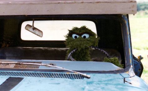 The Muppet Master Encyclopedia — Oscar the Grouch driving in “Follow that Bird.” Sesame Street Muppets, Silly Puppets, Fraggle Rock, Fashion Vogue, Oscar The Grouch, Morning Cartoon, The Muppet Show, Chosen Family, Miss Piggy