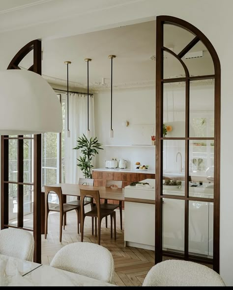 Loving this beautiful Parisian inspiration. All the molding is so amazing - those arched wood doors too! 😍😍😍 Design @verocotrel | Instagram Parisian Room Divider, Arch Window Interior, Living Room With Arched Windows, Arched Opening Between Kitchen And Living Room, Arched Patio Doors, Archway To Dining Room, Arch Panelling Design, Parisian Home Exterior, Arch In Living Room