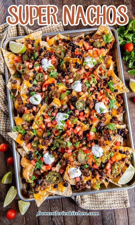 These sheet pan Super Nachos are loaded with ground beef, black beans, homemade nacho cheese sauce, and plenty of freshly shreddded cheese. Just pile on your favorite toppings and dig in! Diy Nachos Ground Beef, Authentic Mexican Nachos Recipe, Fully Loaded Nachos, Blackstone Nachos Supreme, Best Homemade Nachos, Halloween Nachos Ideas, Black Stone Nachos Recipes, Health Nachos, Homemade Nachos Beef