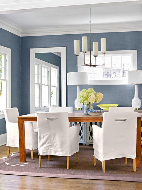 Pairing icy blue walls with plenty of white accents helps the hue come off as cool, not frigid. In this dining room, clean-lined chairs and light fixtures stay true to the simplistic mentality of the room, while wood finishes and a natural weave area rug soften the space, giving it a more organic feel. Room With Blue Walls, Blue Dining Room Walls, Organic Dining Room, Blue Dining Room, Blue Bedroom Walls, Dining Room Paint, Dining Room Blue, Dining Room Remodel, Dining Room Colors