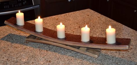 This simple but elegant candle holder is made from two napa valley wine barrel staves. The gorgeous design will add beauty and light to any counter or table top. 30" long, 6" tall and 4" wide Candles not included Feel good about doing business with The Winey Guys, re-inventing what we can, to help our environment. All Winey Guys products are created from recycled wine barrels. Since all barrels are unique in size, character and color, there are slight differences among like products. These variations do not affect the function or durability of Winey Guys products, but do add a one of a kind touch to each piece we create. Enjoy! Barrel Stave Projects, Wine Barrel Diy, Stave Projects, Barrel Stave Ideas, Whiskey Barrel Ideas, Wine Barrel Crafts, Barrel Art, Barrel Crafts, Wine Barrel Decor