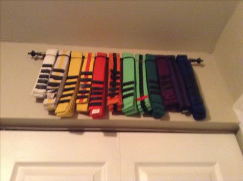 Karate Belt racks were $90 online.... So I bought a $3 towel bar from the dollar store and used it as a belt rack for Jayden's belts Displaying Karate Belts, How To Display Taekwondo Belts, Jujitsu Belt Display, Karate Belt Display Ideas, Display Karate Belts, Karate Belt Display Diy, Black Belt Display, Karate Belt Holder, Taekwondo Belt Display