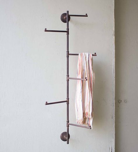 Crafted of solid metal with a rusted finish, this Rustic Wall Swivel Rack adds style to any bathroom, pool house, mudroom, laundry room or covered porch. This rack's metal pipe-like base supports five long hooks that will swivel with ease. Hang hats, towels, jewelry and outerwear on these sturdy hooks. Its distressed design gives the entire piece a rustic farmhouse look. These racks may have slight variations in texture, shape and detail. Indoor or covered outdoor use only. Porch Storage, Wall Mount Rack, Small Basements, Coat Rack Wall, Diy Remodel, Wall Racks, Antique Farmhouse, Rustic Wall, Rustic Walls