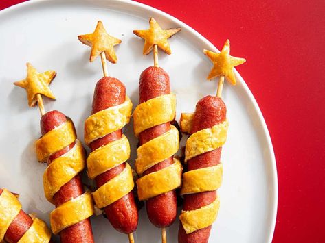 Wrapped in buttery and flaky biscuit dough spirals and finished with a sweet and spicy mustard glaze, these festive firecracker hot dogs are as delicious as they are adorable. Firecracker Hot Dogs, Hot Honey Mustard, Lattice Pie Crust, Tailgating Food, Honey Mustard Glaze, Skewer Sticks, Flaky Biscuits, Biscuit Dough, Small Microwave