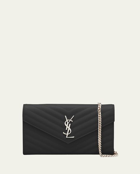 "Find SAINT LAURENT Ysl Monogram Large Wallet On Chain In Grained Leather on Editorialist. Saint Laurent chrome free/metalfree tanned calfskin leather wallet with quilted overstitching. Removable leather and curbchain shoulder strap; 19\" drop. Envelope flaptop with YSL logo medallion; snap closure. Golden metal hardware Center zip compartment divides interior; 10 card slots, two bill compartments, two central compartments, and one zip coin pouch. 5.5\"H x 9\"W x 1.5\"D Approx. weight 1 lb. Made in Italy."